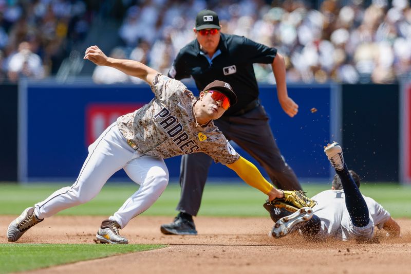 May 26, 2024; San Diego, California, USA; San Diego Padres shortstop Ha-Seong Kim (7) tags the base stealer out at second base during the third inning against the New York Yankees at Petco Park. Mandatory Credit: David Frerker-USA TODAY Sports
