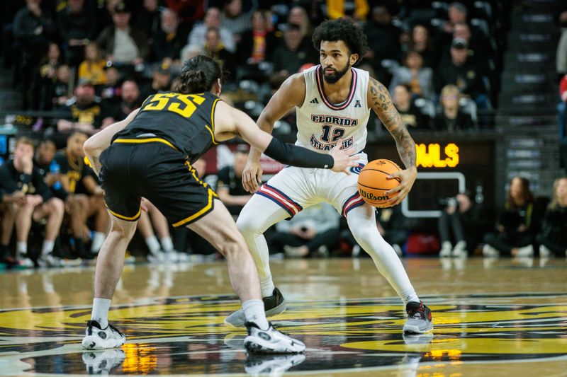 Feb 11, 2024; Wichita, Kansas, USA; Florida Atlantic Owls guard Jalen Gaffney (12) brings the ball up court around Wichita State Shockers guard Bijan Cortes (55) during the second half at Charles Koch Arena. Mandatory Credit: William Purnell-USA TODAY Sports