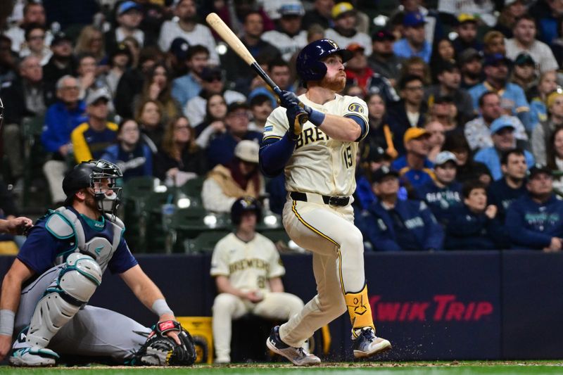 Apr 5, 2024; Milwaukee, Wisconsin, USA; Milwaukee Brewers designated hitter Oliver Dunn (15) hits a solo home run in the fourth inning as Seattle Mariners catcher Cal Raleigh (29) looks on at American Family Field. Mandatory Credit: Benny Sieu-USA TODAY Sports