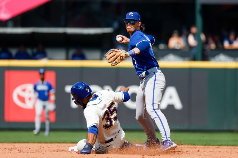 Aug 27, 2023; Seattle, Washington, USA; Kansas City Royals shortstop Bobby Witt Jr. (7) turns a double play against Seattle Mariners designated hitter Teoscar Hernandez (35) during the fourth inning at T-Mobile Park. Mandatory Credit: Joe Nicholson-USA TODAY Sports