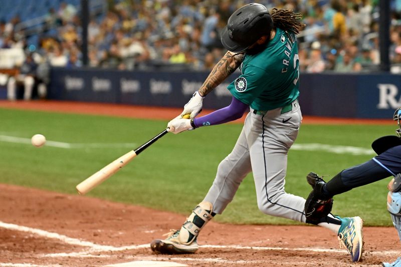 Jun 26, 2024; St. Petersburg, Florida, USA; Seattle Mariners shortstop J.P. Crawford (3) hits a two run single against the Tampa Bay Rays in the seventh inning at Tropicana Field. Mandatory Credit: Jonathan Dyer-USA TODAY Sports