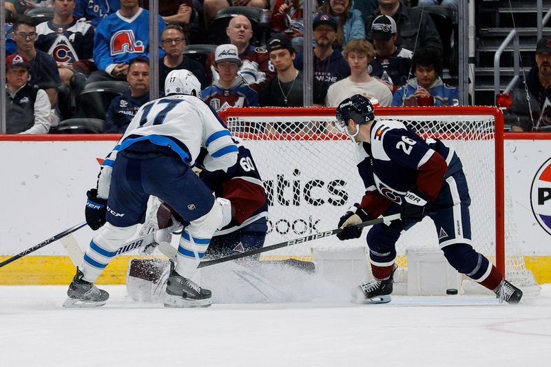 Apr 13, 2024; Denver, Colorado, USA; Winnipeg Jets center Adam Lowry (17) scores on a shot against Colorado Avalanche goaltender Justus Annunen (60) as defenseman Sean Walker (26) defends in the second period at Ball Arena. Mandatory Credit: Isaiah J. Downing-USA TODAY Sports