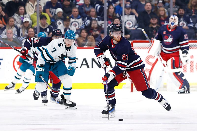 Feb 14, 2024; Winnipeg, Manitoba, CAN; Winnipeg Jets Kyle Connor (81) skates up the ice past San Jose Sharks center Nico Sturm (7) in the second period at Canada Life Centre. Mandatory Credit: James Carey Lauder-USA TODAY Sports