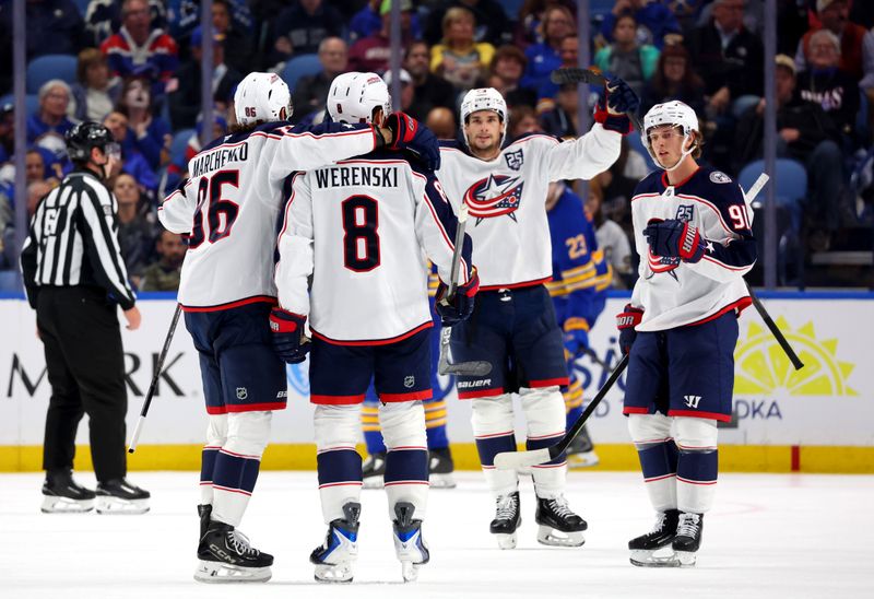 Oct 28, 2025; Buffalo, New York, USA;  Columbus Blue Jackets defenseman Zach Werenski (8) celebrates his goal with teammates during the second period against the Buffalo Sabres at KeyBank Center. Mandatory Credit: Timothy T. Ludwig-Imagn Images
