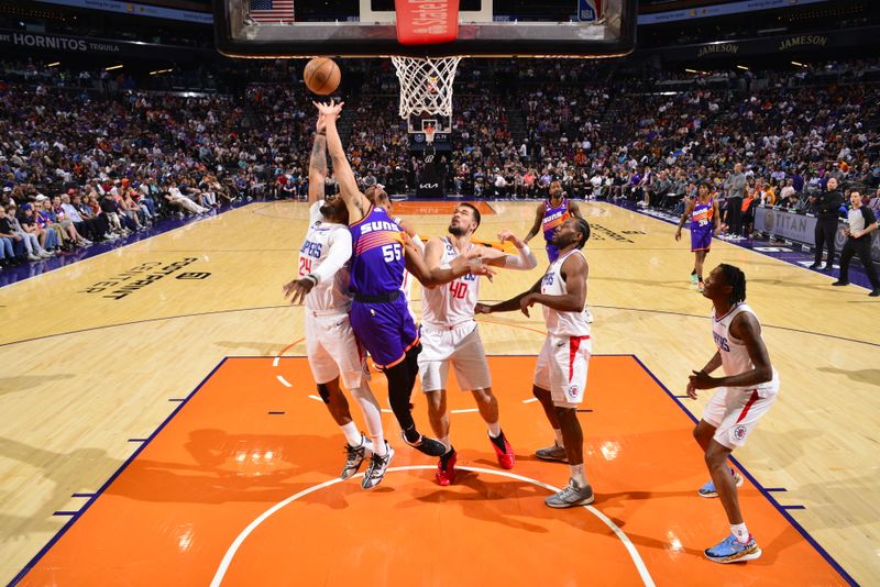 PHOENIX, AZ - APRIL 9: Darius Bazley #55 of the Phoenix Suns and Norman Powell #24 of the LA Clippers go up for the rebound during the game on April 9, 2023 at Footprint Center in Phoenix, Arizona. NOTE TO USER: User expressly acknowledges and agrees that, by downloading and or using this photograph, user is consenting to the terms and conditions of the Getty Images License Agreement. Mandatory Copyright Notice: Copyright 2023 NBAE (Photo by Barry Gossage/NBAE via Getty Images)