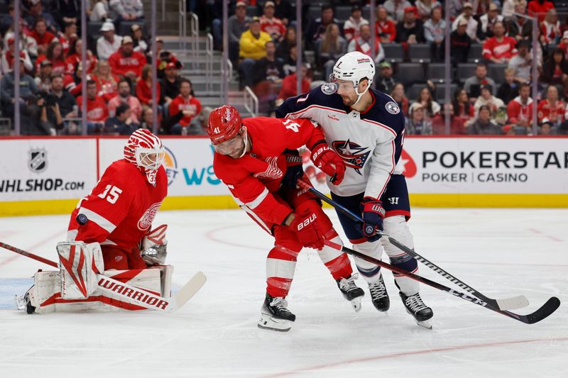 Nov 11, 2023; Detroit, Michigan, USA;  Columbus Blue Jackets center Sean Kuraly (7) and Detroit Red Wings defenseman Shayne Gostisbehere (41) fight for position as Detroit goaltender Ville Husso (35) makes a save in the first period at Little Caesars Arena. Mandatory Credit: Rick Osentoski-USA TODAY Sports