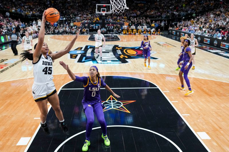 Apr 2, 2023; Dallas, TX, USA; Iowa Hawkeyes forward Hannah Stuelke (45) drives to the basket against LSU Lady Tigers forward LaDazhia Williams (0) in the first half during the final round of the Women's Final Four NCAA tournament at the American Airlines Center. Mandatory Credit: Kirby Lee-USA TODAY Sports