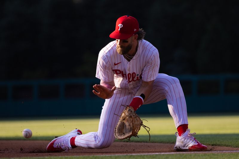 Jun 18, 2024; Philadelphia, Pennsylvania, USA; Philadelphia Phillies first base Bryce Harper (3) fields a ball for an out against the San Diego Padres during the first inning at Citizens Bank Park. Mandatory Credit: Bill Streicher-USA TODAY Sports