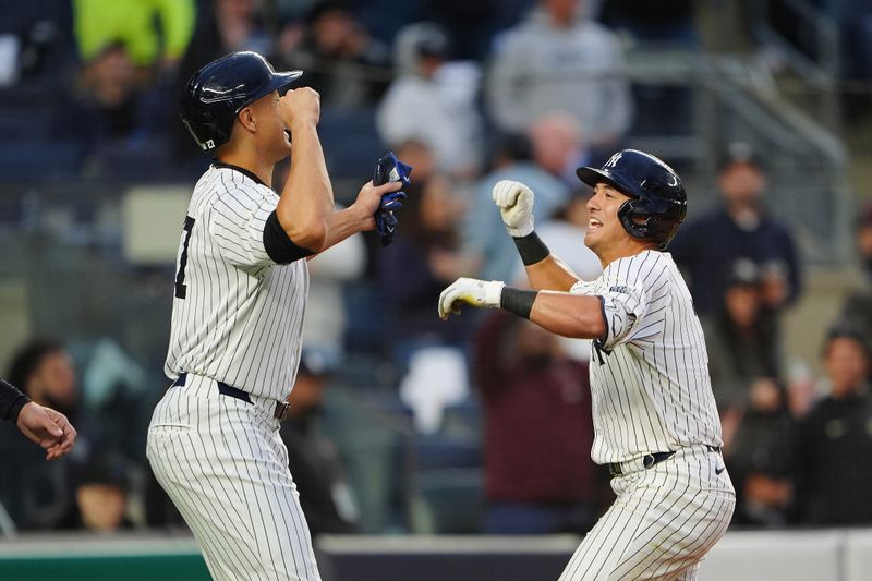 Apr 8, 2024; Bronx, New York, USA; New York Yankees designated hitter Giancarlo Stanton (27) congratulated New York Yankees shortstop Anthony Volpe (11) for hitting a three run home run against the Miami Marlins during the fourth inning at Yankee Stadium. Mandatory Credit: Gregory Fisher-USA TODAY Sports