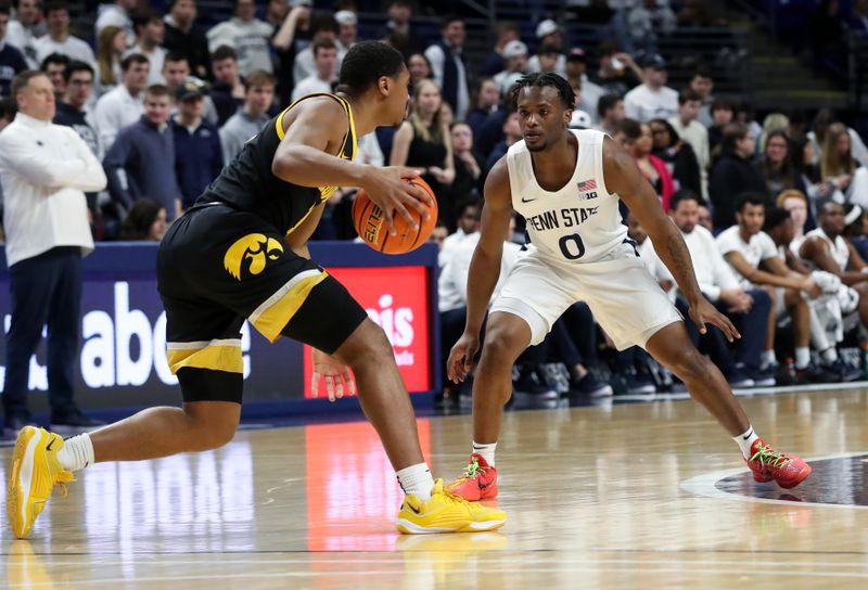 Feb 8, 2024; University Park, Pennsylvania, USA; Penn State Nittany Lions guard Kanye Clary (0) defends as Iowa Hawkeyes guard Tony Perkins (11) dribbles the ball down court during the first half at Bryce Jordan Center. Penn State defeated Iowa 89-79. Mandatory Credit: Matthew O'Haren-USA TODAY Sports