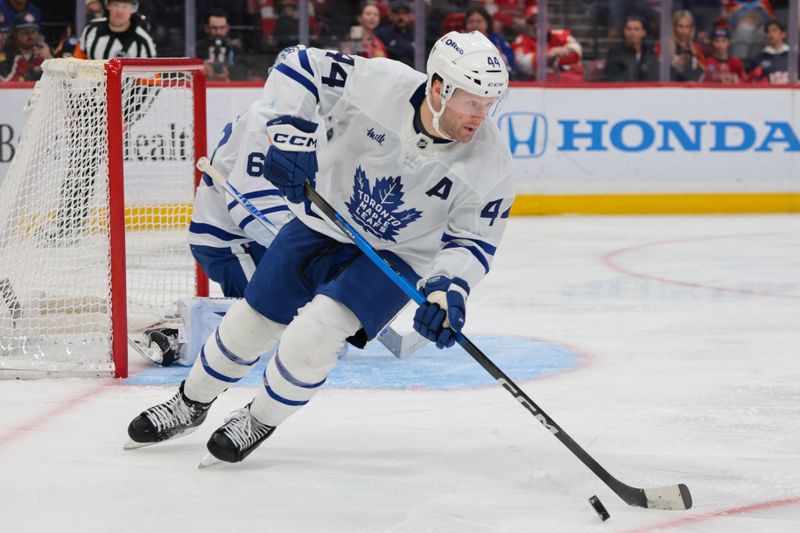Feb 26, 2026; Sunrise, Florida, USA; Toronto Maple Leafs defenseman Morgan Rielly (44) moves the puck against the Florida Panthers during the third period at Amerant Bank Arena. Mandatory Credit: Sam Navarro-Imagn Images
