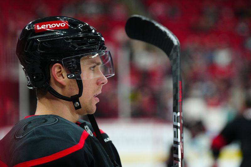 Nov 3, 2024; Raleigh, North Carolina, USA;  Carolina Hurricanes center Jack Drury (18) looks on before the game during the warmups against the Washington Capitals at Lenovo Center. Mandatory Credit: James Guillory-Imagn Images