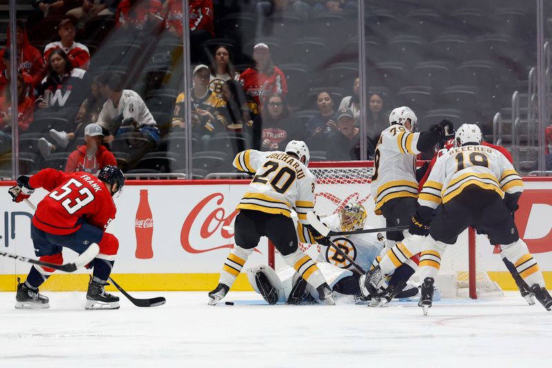 Oct 2, 2025; Washington, District of Columbia, USA; Boston Bruins goaltender Joonas Korpisalo (70) makes a save on Washington Capitals center Ethen Frank (53) in the second period at Capital One Arena. Mandatory Credit: Geoff Burke-Imagn Images
