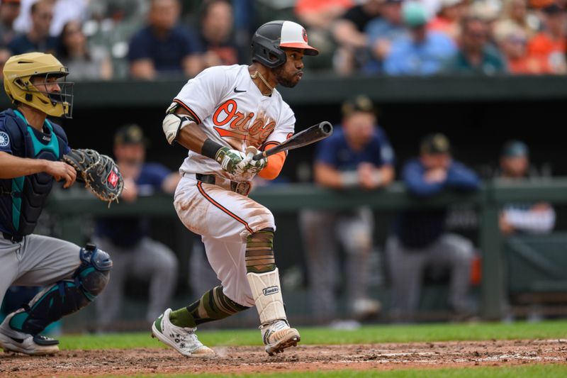 May 19, 2024; Baltimore, Maryland, USA; Baltimore Orioles outfielder Cedric Mullins (31) hits a single during the eighth inning against the Seattle Mariners at Oriole Park at Camden Yards. Mandatory Credit: Reggie Hildred-USA TODAY Sports