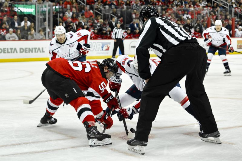 Oct 19, 2024; Newark, New Jersey, USA; New Jersey Devils left wing Erik Haula (56) faces off with Washington Capitals left wing Pierre-Luc Dubois (80) during the first period at Prudential Center. Mandatory Credit: John Jones-Imagn Images