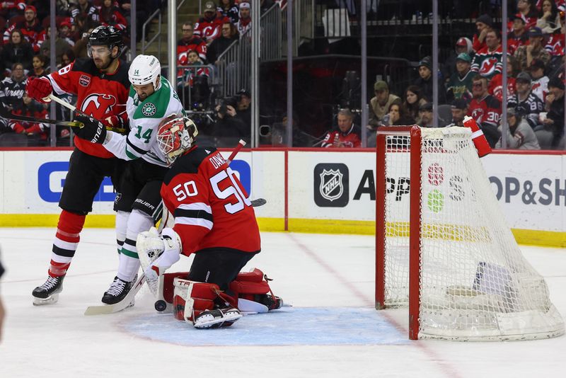 Jan 20, 2024; Newark, New Jersey, USA; New Jersey Devils goaltender Nico Daws (50) makes a save against the Dallas Stars during the first period at Prudential Center. Mandatory Credit: Ed Mulholland-USA TODAY Sports