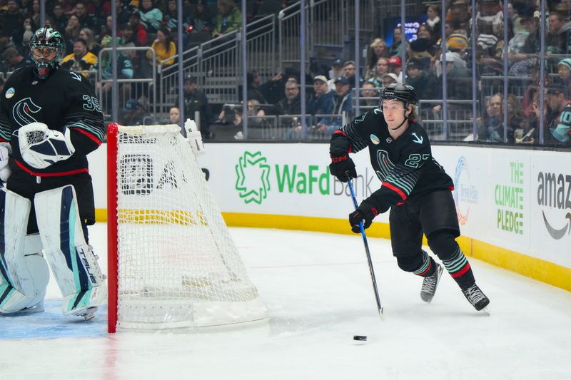Jan 6, 2026; Seattle, Washington, USA; Seattle Kraken center Berkly Catton (27) plays the puck during the first period against the Boston Bruins at Climate Pledge Arena. Mandatory Credit: Steven Bisig-Imagn Images