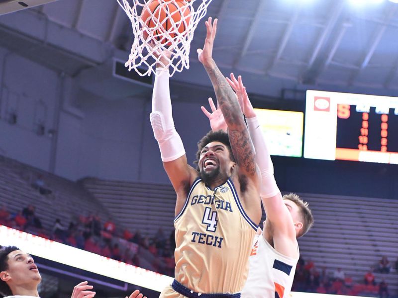 Feb 28, 2023; Syracuse, New York, USA; Georgia Tech Yellow Jackets forward Javon Franklin (4) dunks the ball over Syracuse Orange center Jesse Edwards (14) and guard Justin Taylor (5) in the first half at the JMA Wireless Dome. Mandatory Credit: Mark Konezny-USA TODAY Sports