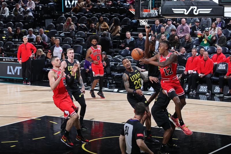 SALT LAKE CITY, UT - MARCH 6: Ayo Dosunmu #12 of the Chicago Bulls passes the ball during the game against the Utah JazzAyo Dosunmu on March 6, 2024 at Delta Center in Salt Lake City, Utah. NOTE TO USER: User expressly acknowledges and agrees that, by downloading and or using this Photograph, User is consenting to the terms and conditions of the Getty Images License Agreement. Mandatory Copyright Notice: Copyright 2024 NBAE (Photo by Melissa Majchrzak/NBAE via Getty Images)