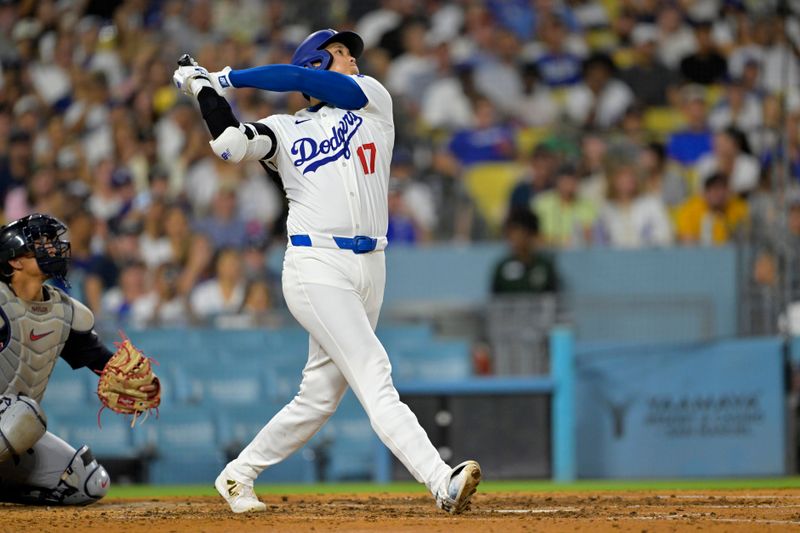 Sep 6, 2024; Los Angeles, California, USA;  Los Angeles Dodgers designated hitter Shohei Ohtani (17) hits his 45th home run on the season in the sixth inning against the Cleveland Guardians at Dodger Stadium. Mandatory Credit: Jayne Kamin-Oncea-Imagn Images