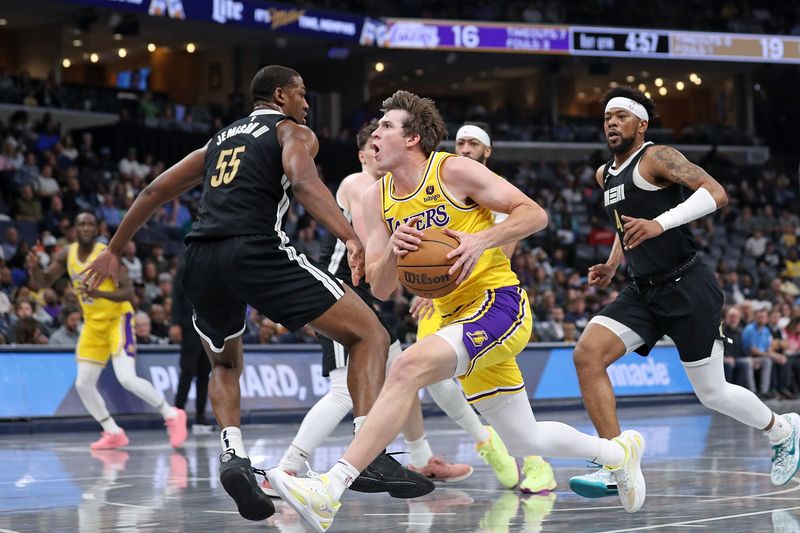 MEMPHIS, TENNESSEE - APRIL 12: Austin Reaves #15 of the Los Angeles Lakers drives to the basket against Trey Jemison #55 of the Memphis Grizzlies during the first half at FedExForum on April 12, 2024 in Memphis, Tennessee. NOTE TO USER: User expressly acknowledges and agrees that, by downloading and or using this photograph, User is consenting to the terms and conditions of the Getty Images License Agreement. (Photo by Justin Ford/Getty Images)