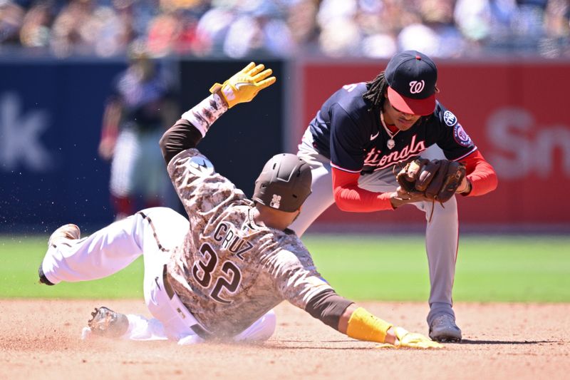 Jun 25, 2023; San Diego, California, USA; San Diego Padres designated hitter Nelson Cruz (32) is forced out at second base by Washington Nationals shortstop C.J. Abrams (right) during the fifth inning at Petco Park. Mandatory Credit: Orlando Ramirez-USA TODAY Sports