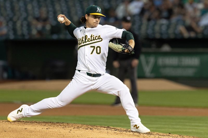 Sep 3, 2024; Oakland, California, USA; Oakland Athletics starting pitcher J.T. Ginn (70) delivers a pitch against the Seattle Mariners during the fourth inning at Oakland-Alameda County Coliseum. Mandatory Credit: D. Ross Cameron-Imagn Images