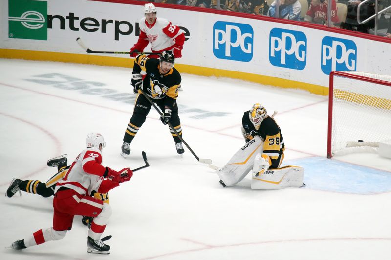 Nov 13, 2024; Pittsburgh, Pennsylvania, USA;  Detroit Red Wings defenseman Simon Edvinsson (77) scores the game winning goal in overtime against Pittsburgh Penguins goaltender Alex Nedeljkovic (39) at PPG Paints Arena. Mandatory Credit: Charles LeClaire-Imagn Images