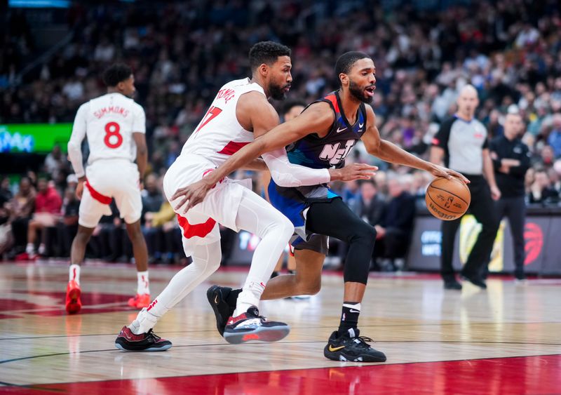 TORONTO, ON - MARCH 25:  Mikal Bridges #1 of the Brooklyn Nets drives by Garrett Temple #17 of the Toronto Raptors during the first half at the Scotiabank Arena on March 25, 2024 in Toronto, Ontario, Canada. NOTE TO USER: User expressly acknowledges and agrees that, by downloading and/or using this Photograph, user is consenting to the terms and conditions of the Getty Images License Agreement. (Photo by Mark Blinch/Getty Images)