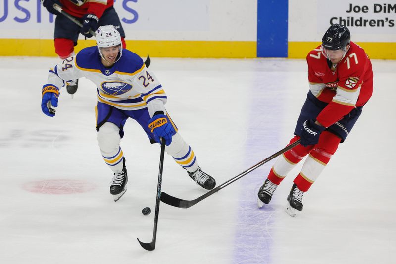 Feb 27, 2024; Sunrise, Florida, USA; Buffalo Sabres center Dylan Cozens (24) protects the puck from Florida Panthers defenseman Niko Mikkola (77) during the first period at Amerant Bank Arena. Mandatory Credit: Sam Navarro-USA TODAY Sports