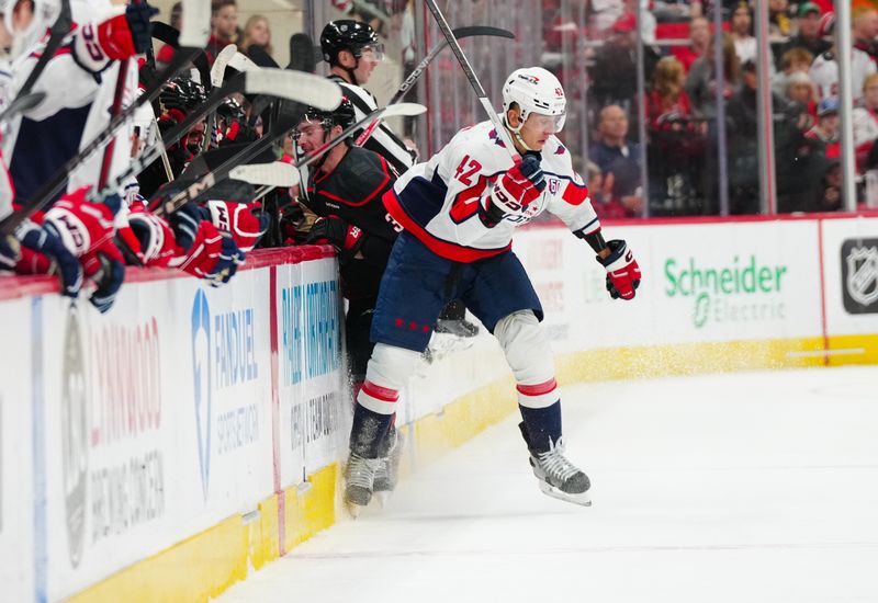 Nov 3, 2024; Raleigh, North Carolina, USA;  Washington Capitals defenseman Martin Fehervary (42) checks Carolina Hurricanes right wing Andrei Svechnikov (37)during the third period at Lenovo Center. Mandatory Credit: James Guillory-Imagn Images