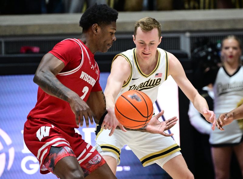 Mar 10, 2024; West Lafayette, Indiana, USA; Purdue Boilermakers guard Fletcher Loyer (2) and Wisconsin Badgers guard AJ Storr (2) go after a loose ball during the first half at Mackey Arena. Mandatory Credit: Marc Lebryk-USA TODAY Sports