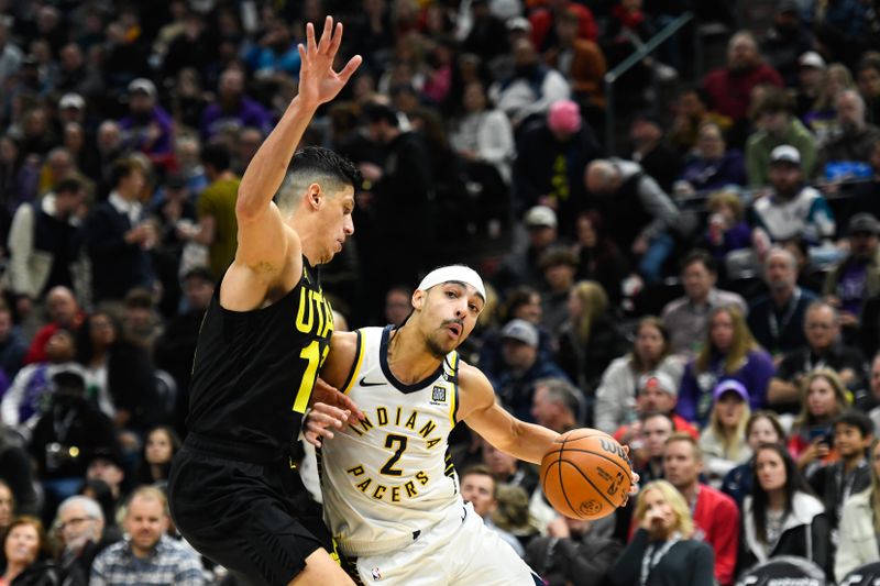 SALT LAKE CITY, UTAH - JANUARY 15: Andrew Nembhard #2 of the Indiana Pacers drives against Simone Fontecchio #16 of the Utah Jazz during the second half of a game at Delta Center on January 15, 2024 in Salt Lake City, Utah. NOTE TO USER: User expressly acknowledges and agrees that, by downloading and or using this photograph, User is consenting to the terms and conditions of the Getty Images License Agreement. (Photo by Alex Goodlett/Getty Images)