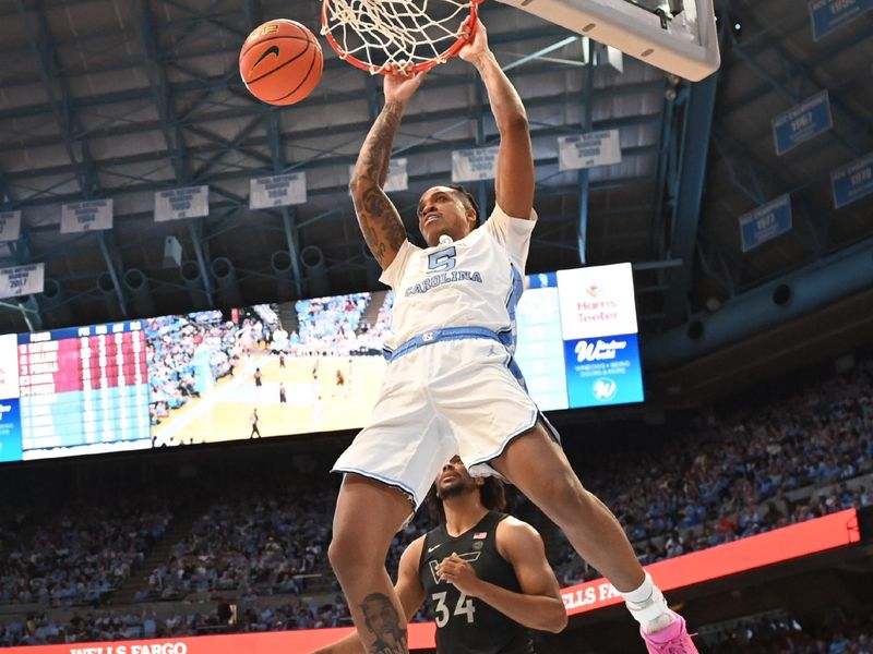 Feb 17, 2024; Chapel Hill, North Carolina, USA; North Carolina Tar Heels forward Armando Bacot (5) scores as Virginia Tech Hokies forward Mylyjael Poteat (34) defends in the second half at Dean E. Smith Center. Mandatory Credit: Bob Donnan-USA TODAY Sports