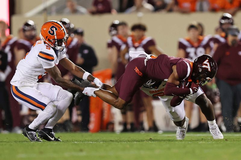 Oct 26, 2023; Blacksburg, Virginia, USA; Virginia Tech Hokies wide receiver Da'Wain Lofton (3) is tackled by Syracuse Orange defensive back Alijah Clark (5) and linebacker Marlowe Wax (2) during the first quarter at Lane Stadium. Mandatory Credit: Peter Casey-USA TODAY Sports