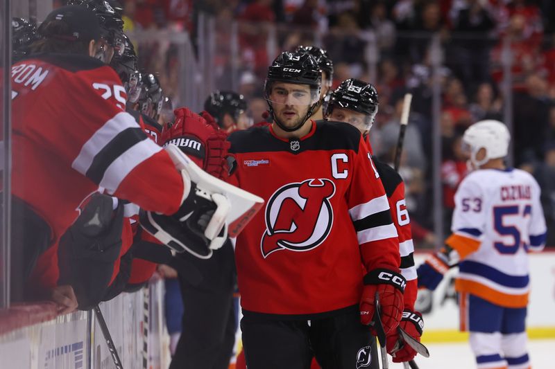 Oct 25, 2024; Newark, New Jersey, USA; New Jersey Devils center Nico Hischier (13) celebrates his goal against the New York Islanders during the first period at Prudential Center. Mandatory Credit: Ed Mulholland-Imagn Images