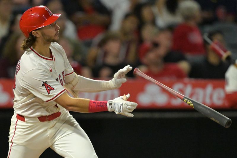 Sep 23, 2025; Anaheim, California, USA;  Los Angeles Angels center fielder Bryce Teodosio (22) hits a two-run shot for his first major league home run scoring second baseman Christian Moore (4) during the fifth inning against the Kansas City Royals at Angel Stadium. Mandatory Credit: Jayne Kamin-Oncea-Imagn Images