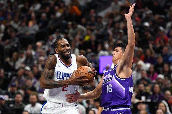 SALT LAKE CITY, UTAH - DECEMBER 08: Kawhi Leonard #2 of the LA Clippers drives into Simone Fontecchio #16 of the Utah Jazz during the second half of a game at Delta Center on December 08, 2023 in Salt Lake City, Utah. NOTE TO USER: User expressly acknowledges and agrees that, by downloading and or using this photograph, User is consenting to the terms and conditions of the Getty Images License Agreement. (Photo by Alex Goodlett/Getty Images)