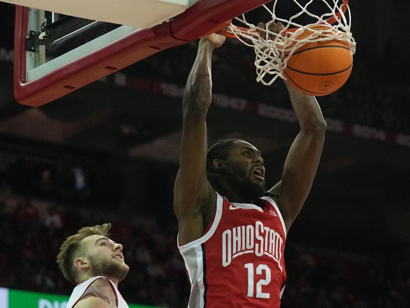 Feb 13, 2024; Madison, Wisconsin, USA;. Ohio State guard Evan Mahaffey (12) scores on Wisconsin forward Tyler Wahl (5) during the first half of their game at the Kohl Center. Mandatory Credit: Mark Hoffman/Milwaukee Journal Sentinelf-USA TODAY Sports
