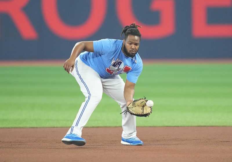 Jun 28, 2023; Toronto, Ontario, CAN; Toronto Blue Jays first baseman Vladimir Guerrero Jr. (27) fields balls during batting practice against the San Francisco Giants at Rogers Centre. Mandatory Credit: Nick Turchiaro-USA TODAY Sports