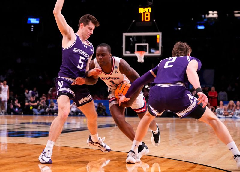 March 22, 2024, Brooklyn, NY, USA; Florida Atlantic Owls guard Johnell Davis (1) drives between Northwestern Wildcats guard Ryan Langborg (5) and Northwestern Wildcats forward Nick Martinelli (2) in the first round of the 2024 NCAA Tournament at the Barclays Center. Mandatory Credit: Robert Deutsch-USA TODAY Sports