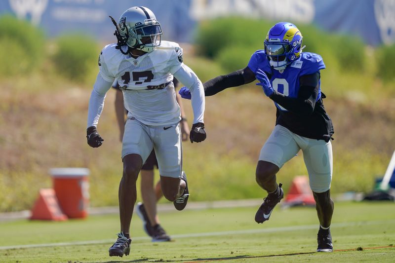 Las Vegas Raiders wide receiver Davante Adams (17) participates in a drill against Los Angeles Rams cornerback Robert Rochell (8) during a joint NFL football practice, Wednesday, Aug. 16, 2023, in Thousand Oaks, Calif. (AP Photo/Ryan Sun)