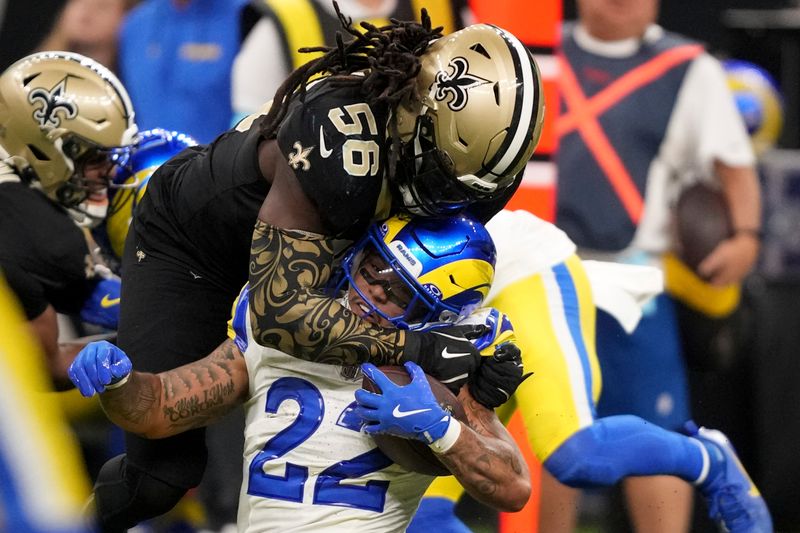 Los Angeles Rams running back Blake Corum (22) is tackled by New Orleans Saints linebacker Demario Davis (56) during the second half of an NFL football game Sunday, Dec. 1, 2024, in New Orleans. (AP Photo/Gerald Herbert)