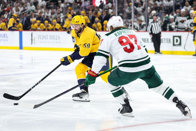 Nov 30, 2024; Saint Paul, Minnesota, USA; Nashville Predators defenseman Roman Josi (59) skates with the puck as Minnesota Wild left wing Kirill Kaprizov (97) defends during the first period at Xcel Energy Center. Mandatory Credit: Matt Krohn-Imagn Images