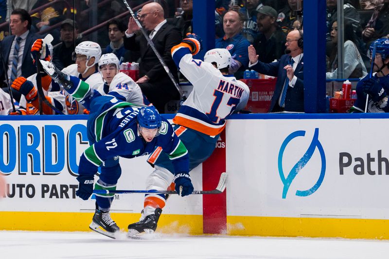 Nov 15, 2023; Vancouver, British Columbia, CAN; Vancouver Canucks forward Anthony Beauvillier (72) collides with New York Islanders forward Matt Martin (17) in the first period at Rogers Arena. Mandatory Credit: Bob Frid-USA TODAY Sports