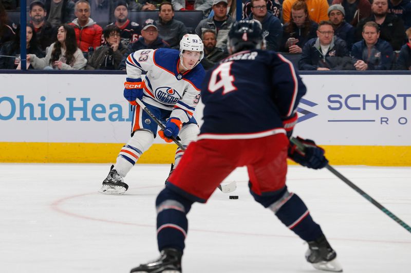 Mar 7, 2024; Columbus, Ohio, USA; Edmonton Oilers center Ryan Nugent-Hopkins (93) passes the puck as Columbus Blue Jackets Forward Cole Sillinger (4) defends during the third period at Nationwide Arena. Mandatory Credit: Russell LaBounty-USA TODAY Sports