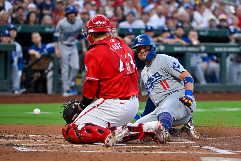 Aug 16, 2024; St. Louis, Missouri, USA;  Los Angeles Dodgers shortstop Miguel Rojas (11) slides safely in at home after St. Louis Cardinals catcher Pedro Pages (43) dropped the ball during the second inning at Busch Stadium. Mandatory Credit: Jeff Curry-USA TODAY Sports