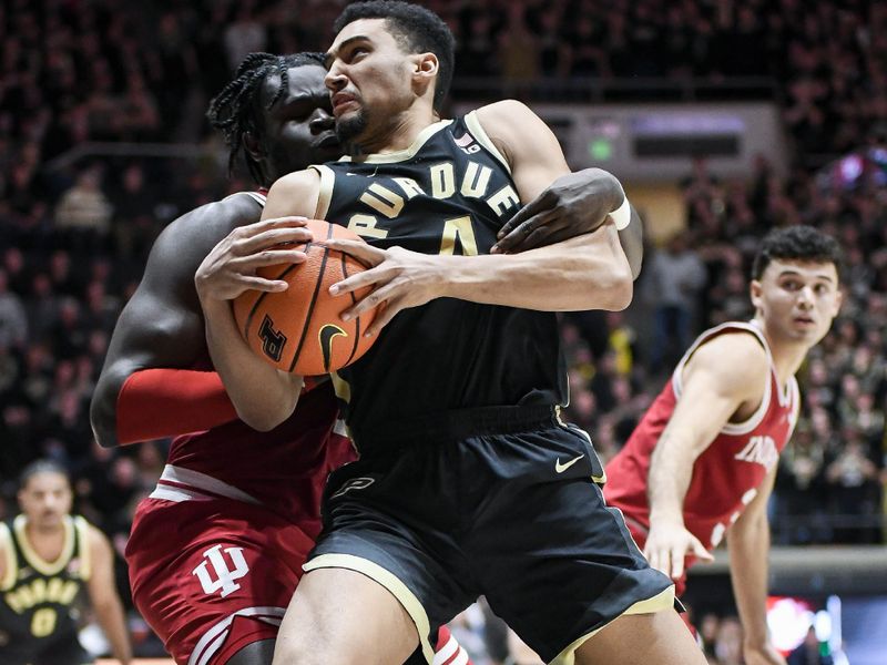 Jan 31, 2025; West Lafayette, Indiana, USA; Purdue Boilermakers forward Trey Kaufman-Renn (4) goes to the basket against Indiana Hoosiers center Oumar Ballo (11) during the second half at Mackey Arena. Mandatory Credit: Robert Goddin-Imagn Images