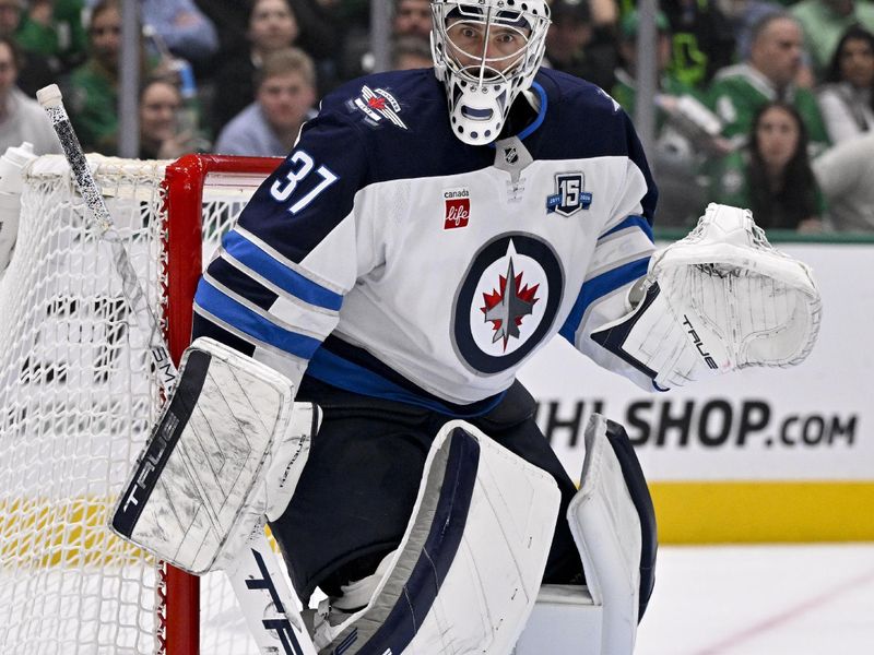 Feb 2, 2026; Dallas, Texas, USA; Winnipeg Jets goaltender Connor Hellebuyck (37) faces the Dallas Stars attack during the second period at the American Airlines Center. Mandatory Credit: Jerome Miron-Imagn Images