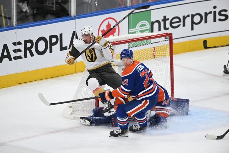 May 10, 2025; Edmonton, Alberta, CAN; Vegas Golden Knights right winger Reilly Smith (19) collides with Edmonton Oilers goalie Stuart Skinner (74) as Oilers centre Trent Frederic (21) skates past during the first period in game three of the second round of the 2025 Stanley Cup Playoffs at Rogers Place. Mandatory Credit: Walter Tychnowicz-Imagn Images